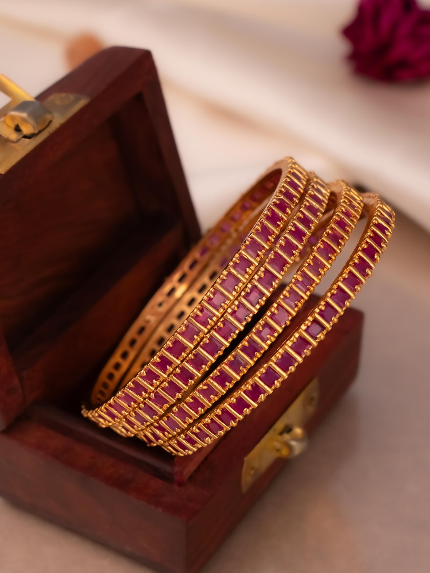 Simple four set ruby stone bangles to match your outfit.
