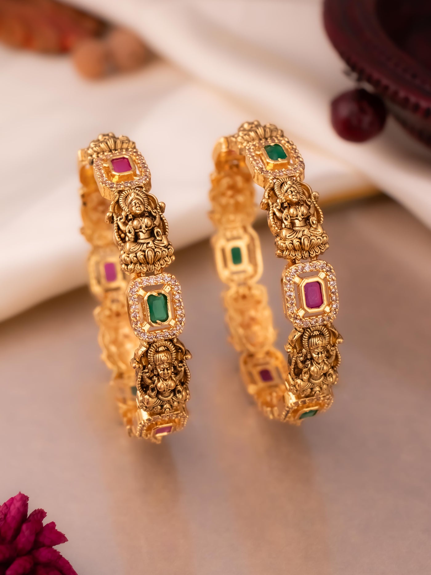 Heavy lakshmi bangles in ruby-green colour stones with AD stone studding.

