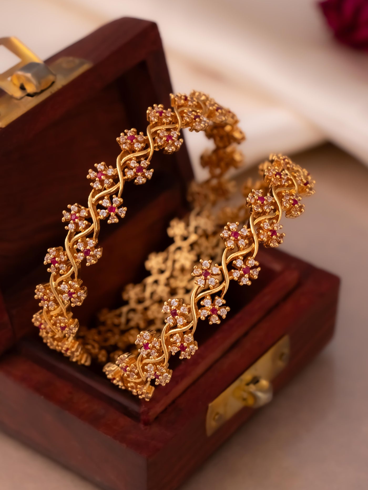 Pari cz gold  flower bangles in white stone and ruby stone at the centre

