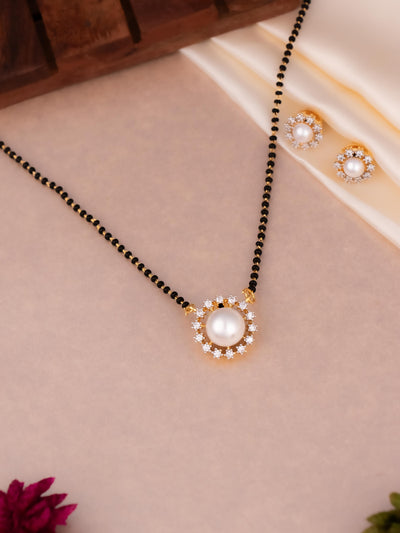 Peral mangalsutra in American diamonds, this unique flower pattern black beads comes with pair of earrings.
