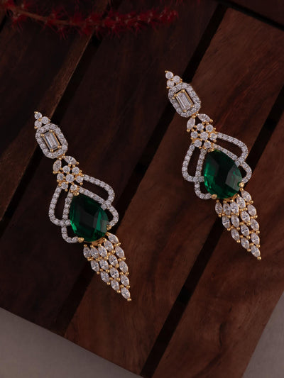 Gold tone diamond earrings in green colour.